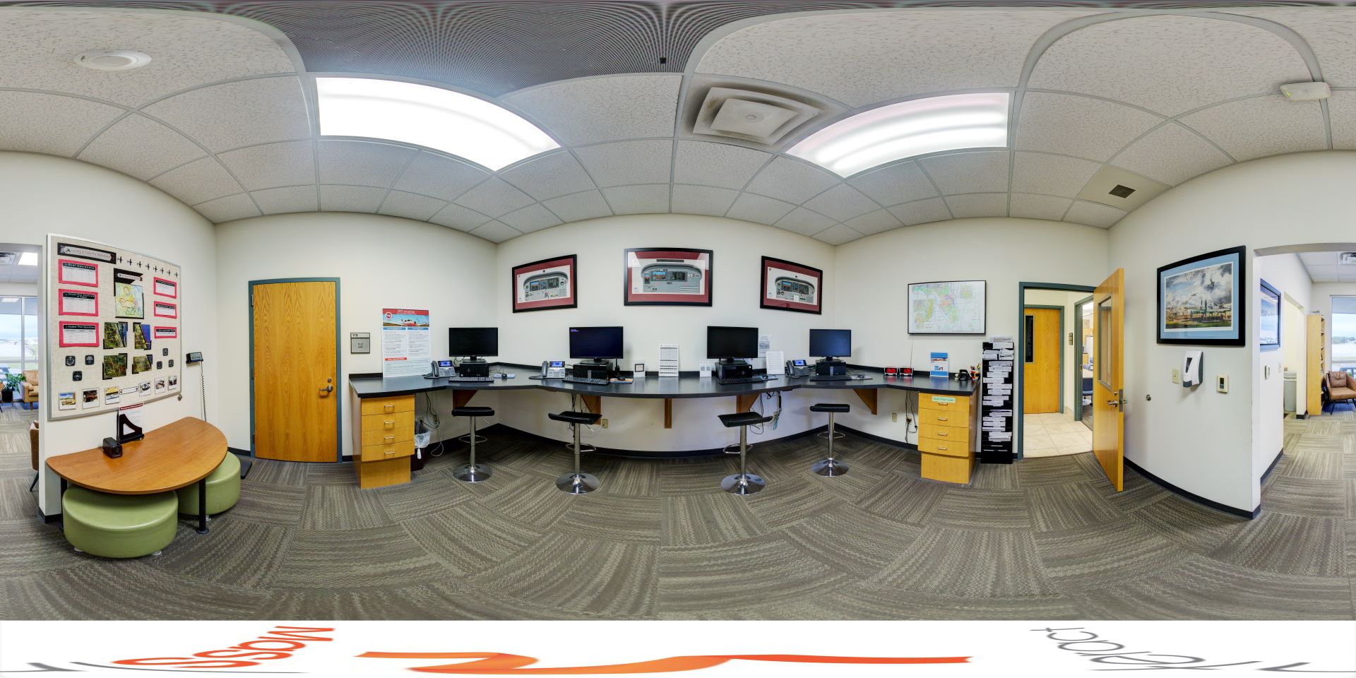Panoramic view of a computer lounge with multiple computers available for use